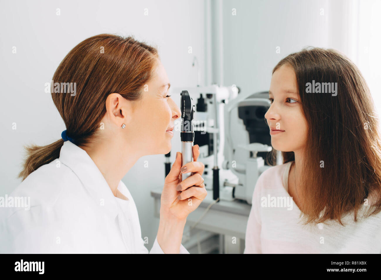 girl getting eye exam at doctors office. Children eye examination
