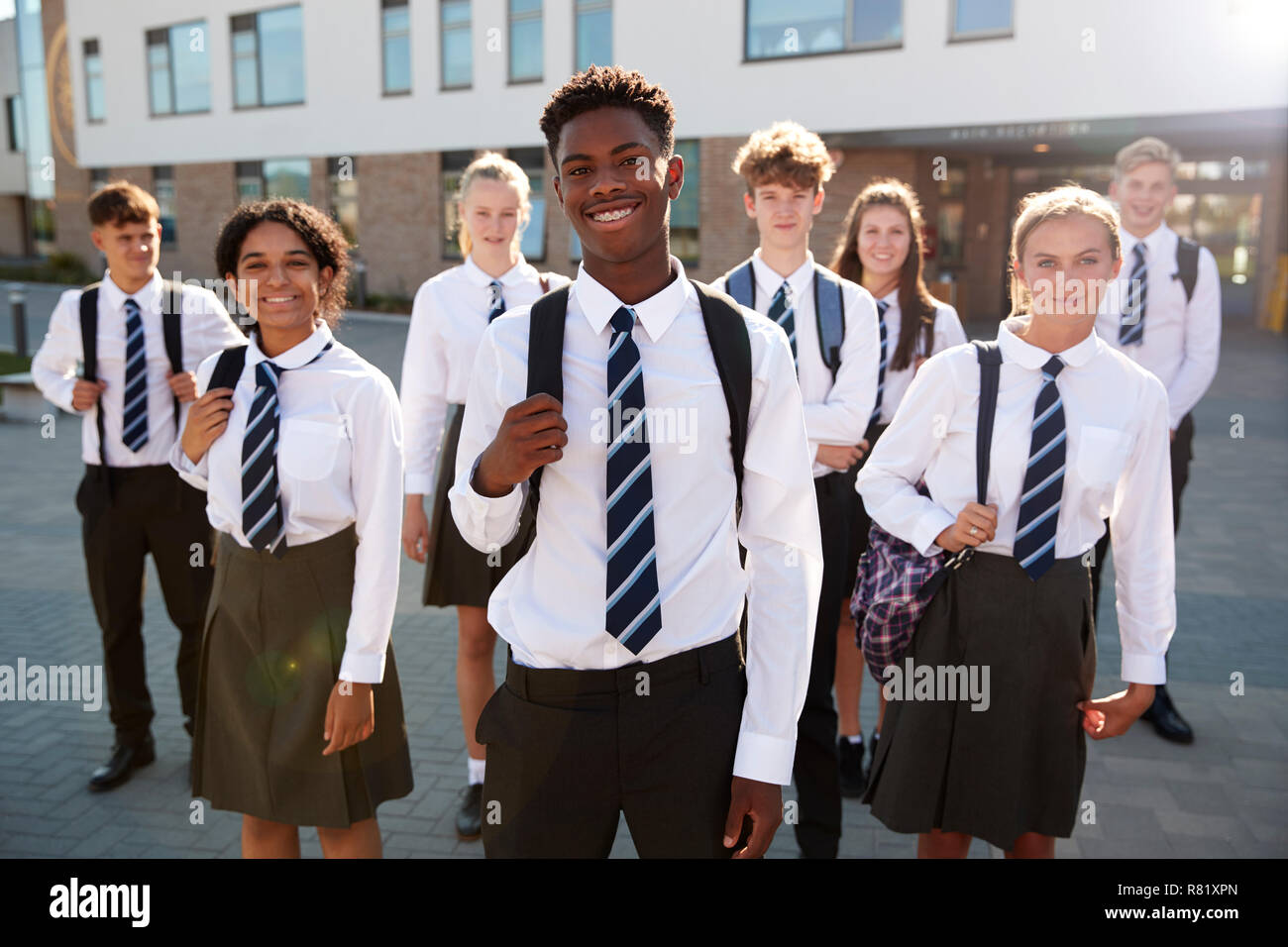 Portrait Of Smiling Male And Female High School Students Wearing Uniform Outside College Building Stock Photo