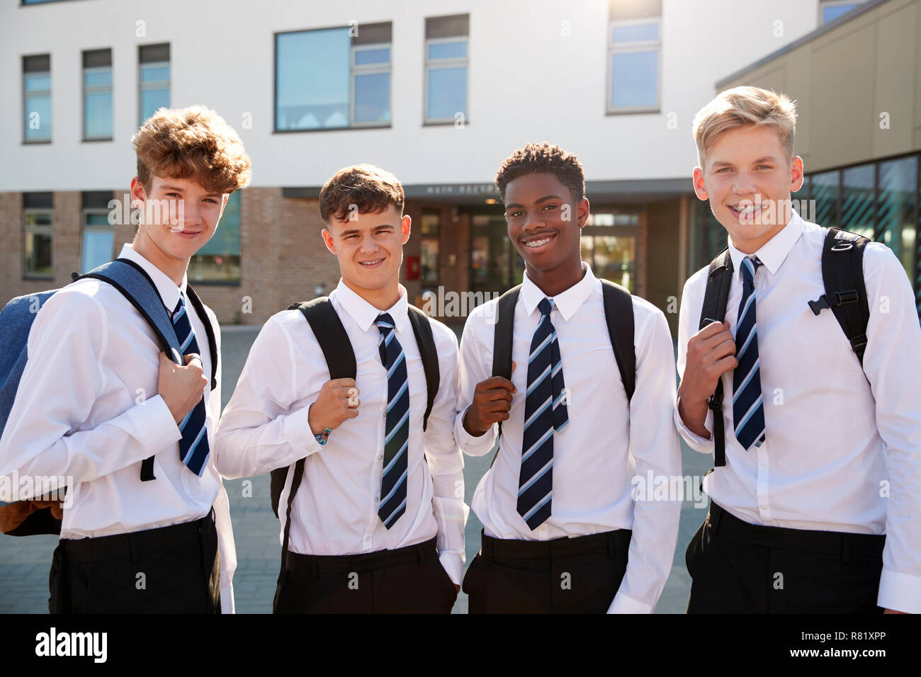 Portrait Of Smiling Male High School Students Wearing Uniform Outside College Building Stock Photo