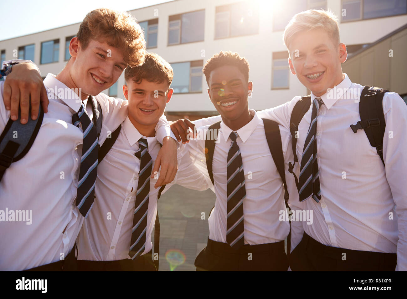Portrait Of Smiling Male High School Students Wearing Uniform Outside College Building Stock Photo