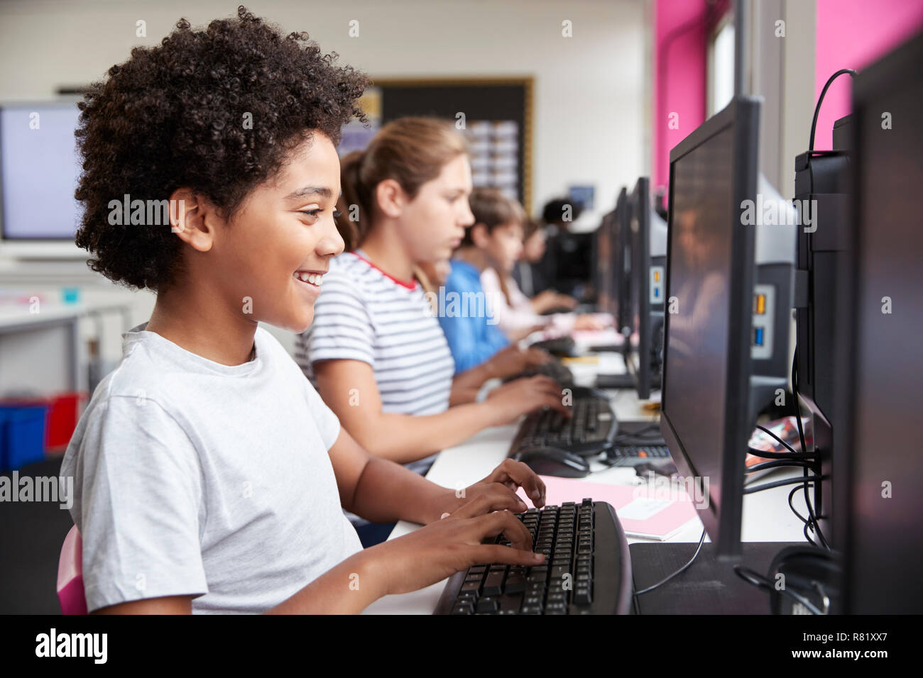 Line Of High School Students Working at Screens In Computer Class Stock Photo