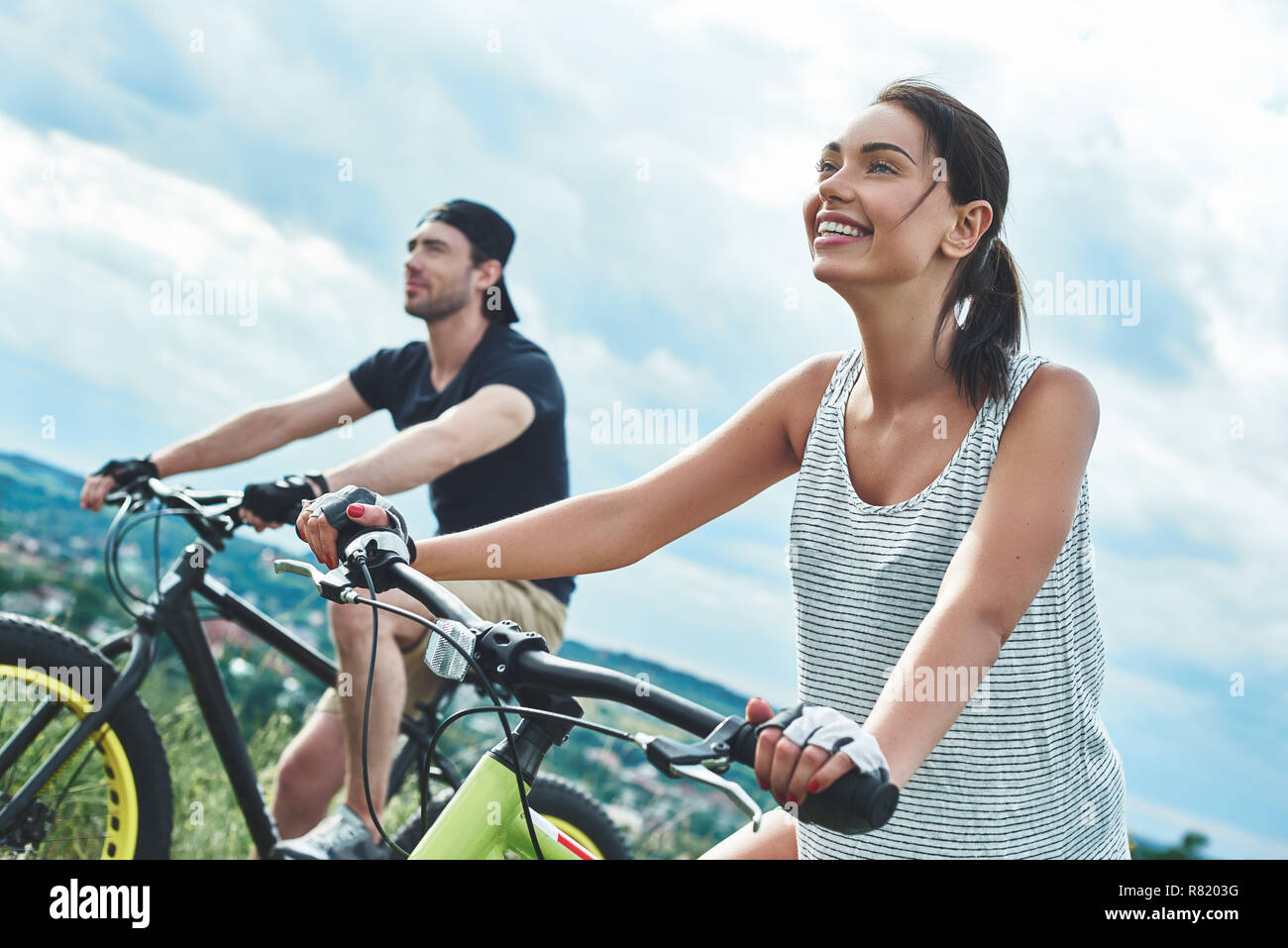 A man and a woman are laughing and cycling. Close up view Stock Photo