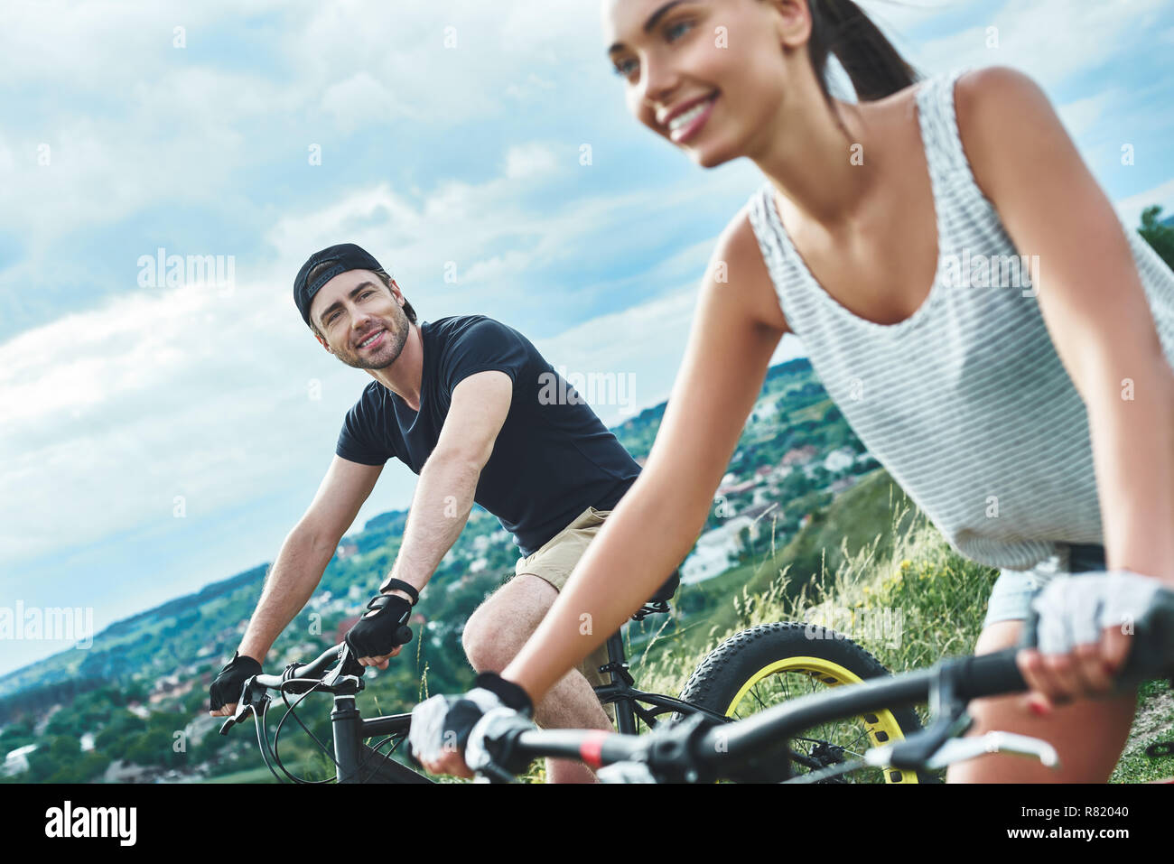 A man and a woman are laughing and cycling. Close up view Stock Photo