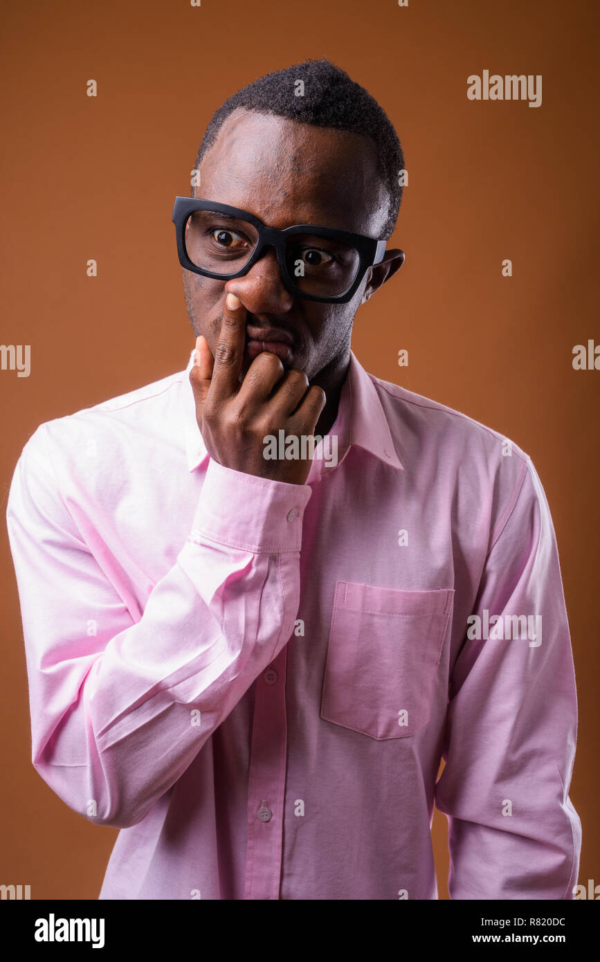 Portrait of young African man picking up his nose Stock Photo
