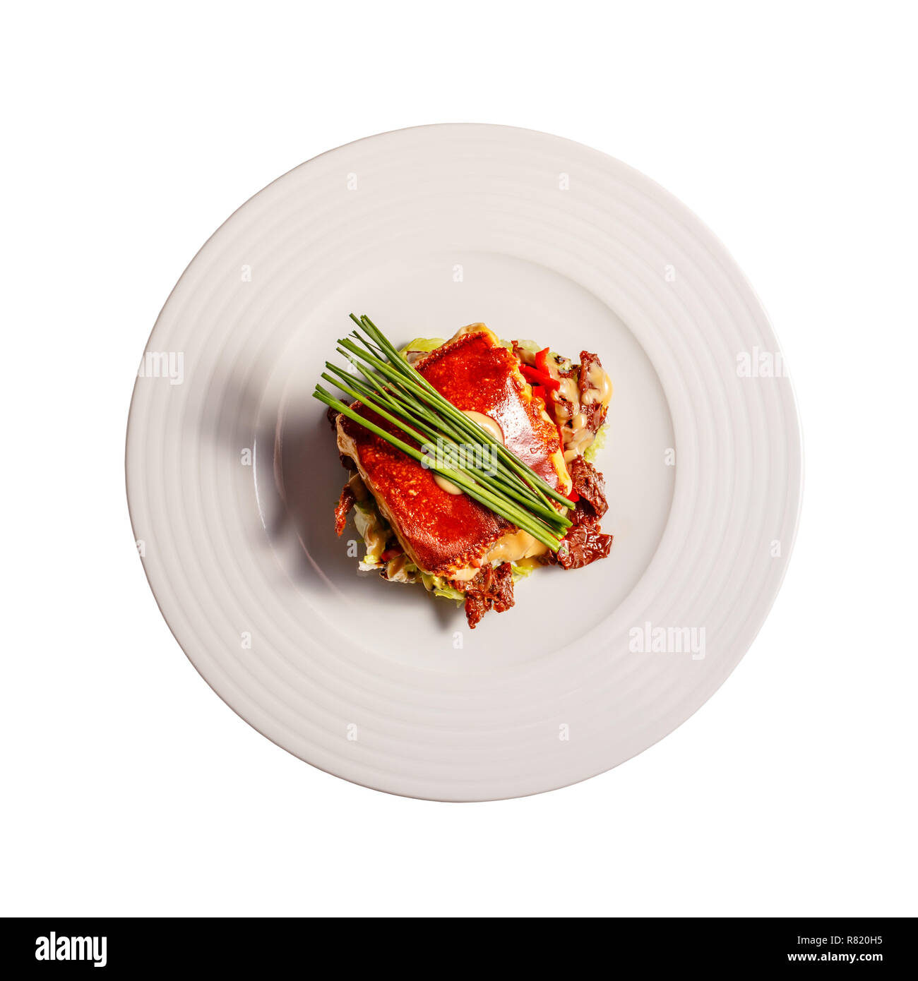 Flat lay of grilled homemade cheese with mustard and honey salad and dried tomatoes on white background Stock Photo