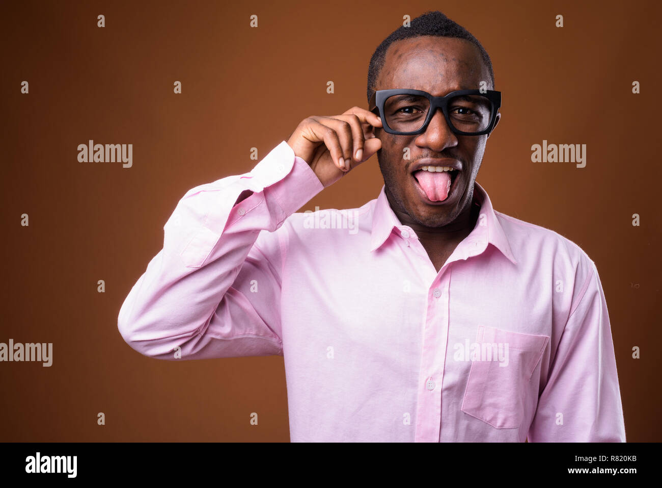Portrait of sad young African businessman crying Stock Photo