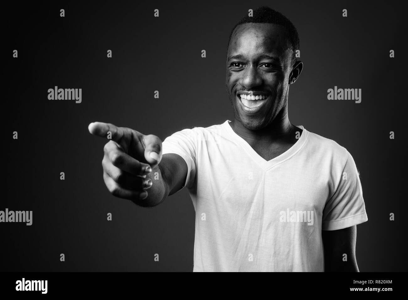 Young African man laughing and pointing finger Stock Photo