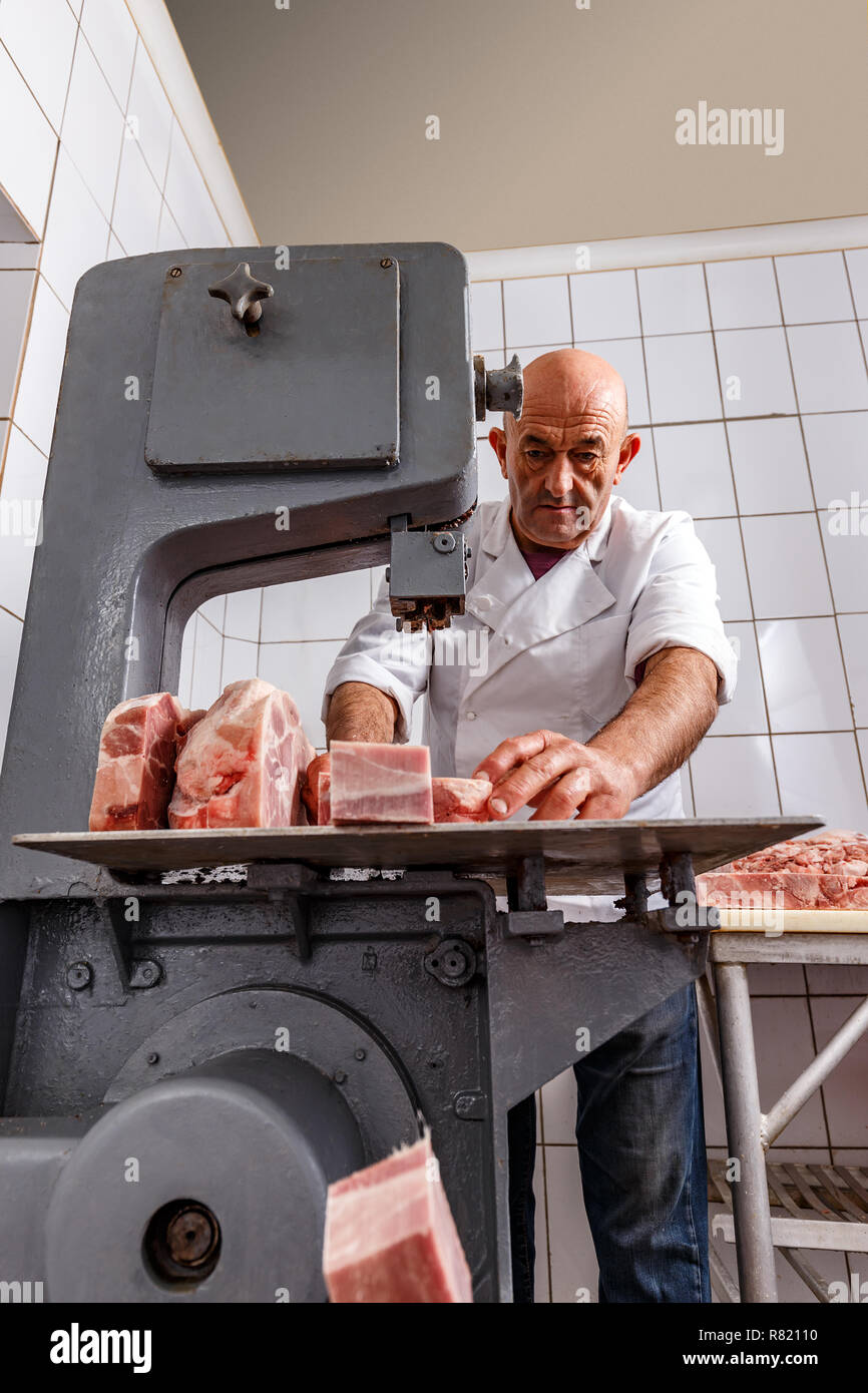 Band saw cuts meat in a meat factory Stock Photo Alamy