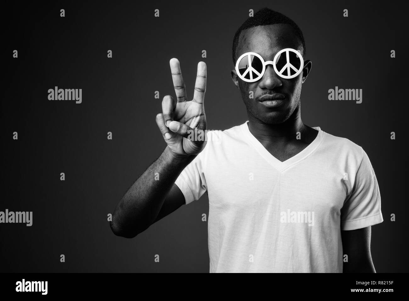 Young African man wearing peace sunglasses and making peaceful gesture Stock Photo