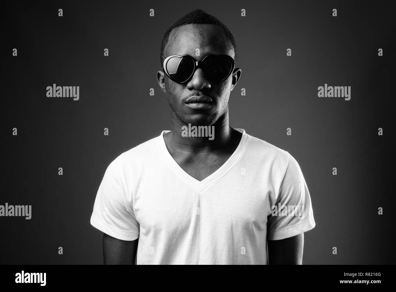 Young African man wearing sunglasses in black and white Stock Photo
