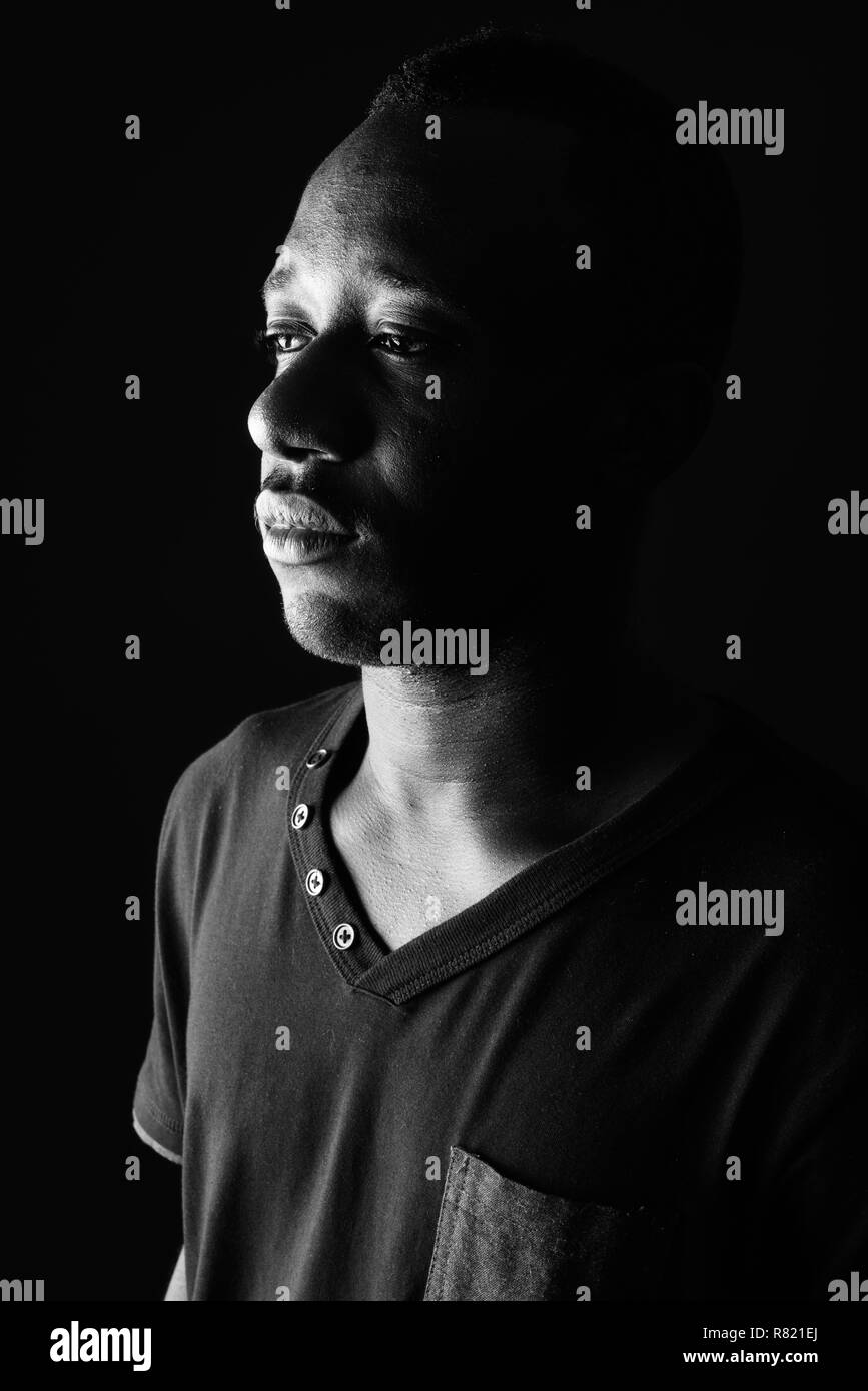 Face of sad young African man in black and white Stock Photo