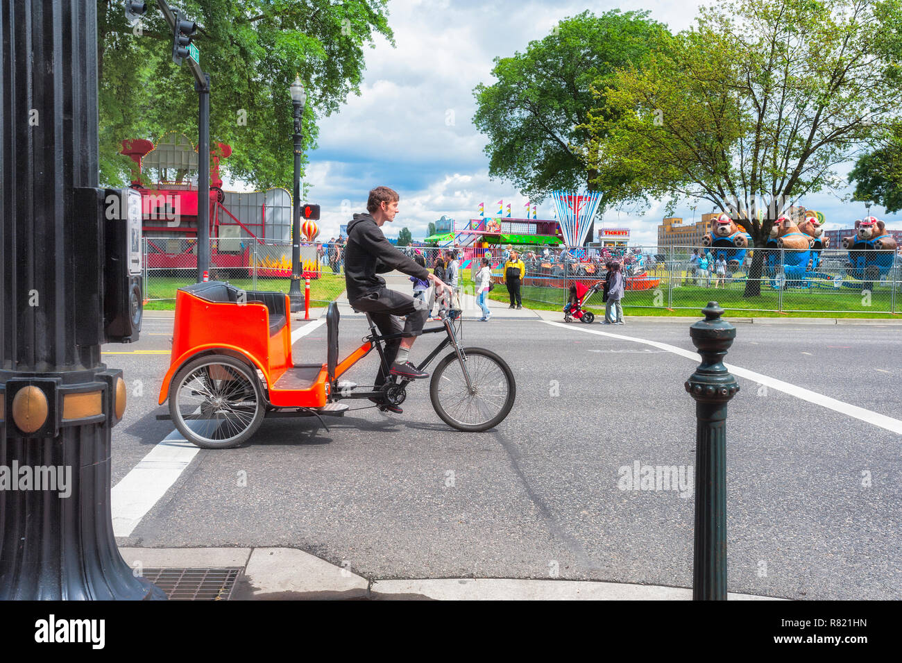 Portland, Oregon, USA - May 29, 2016:  Bicycle Cab in Portland Oregon along the waterfront where a carnival is going on. Stock Photo