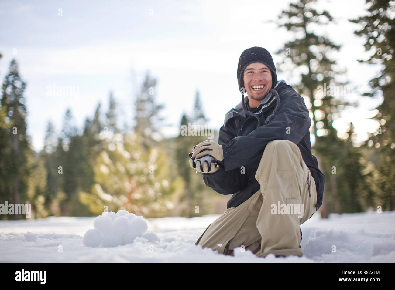 Young man preparing to throw a snowball Stock Photo