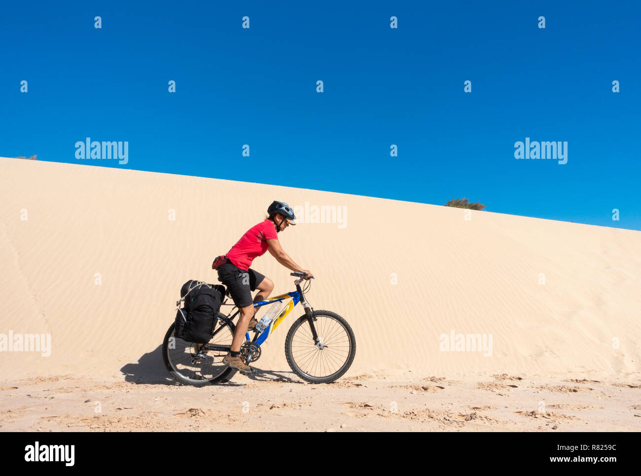 Mature female cyclist touring on Fuerteventura, Canary Islands, Spain Stock Photo