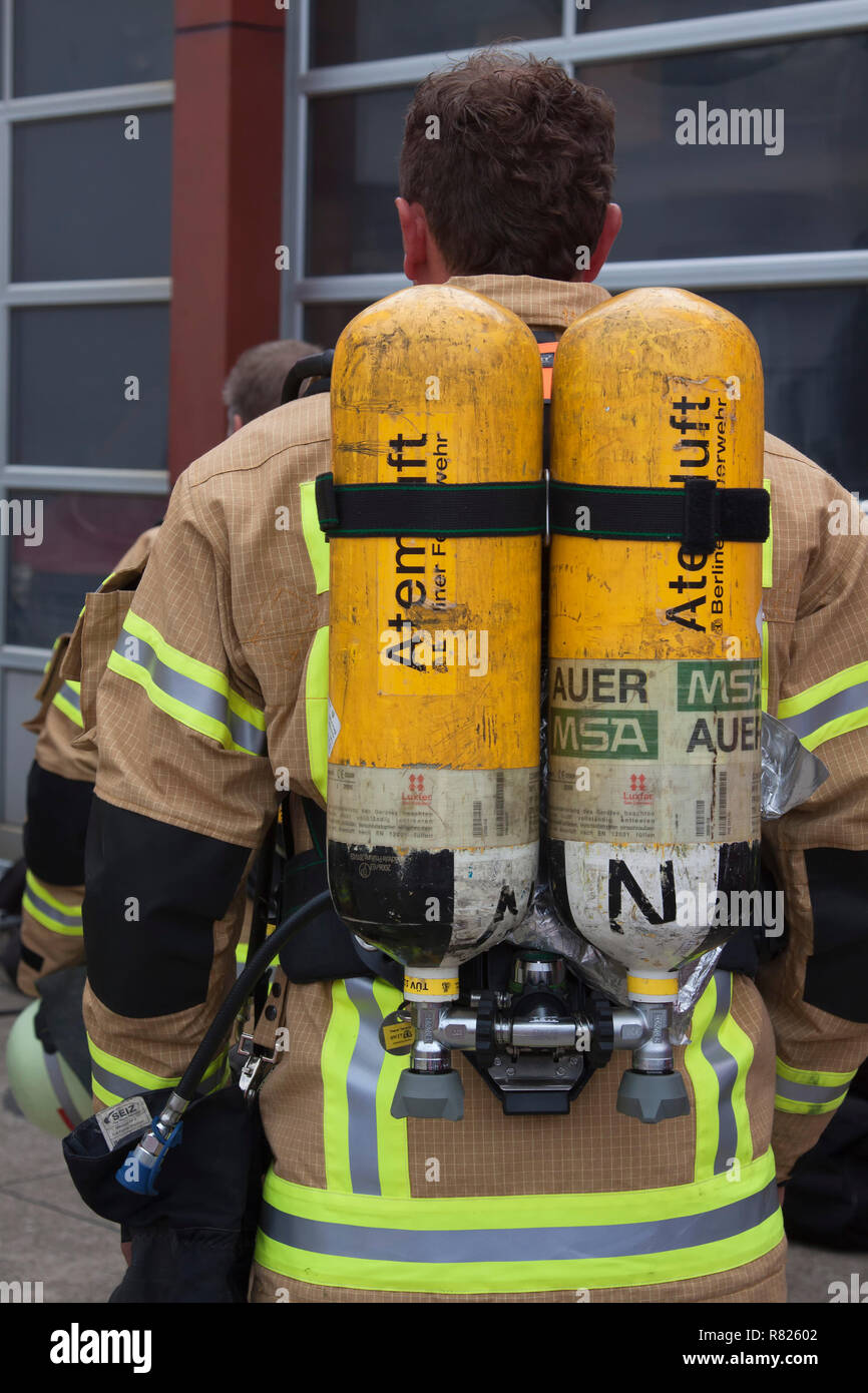 Firefighter with breathing air bottles on his back, Berlin, Germany Stock Photo