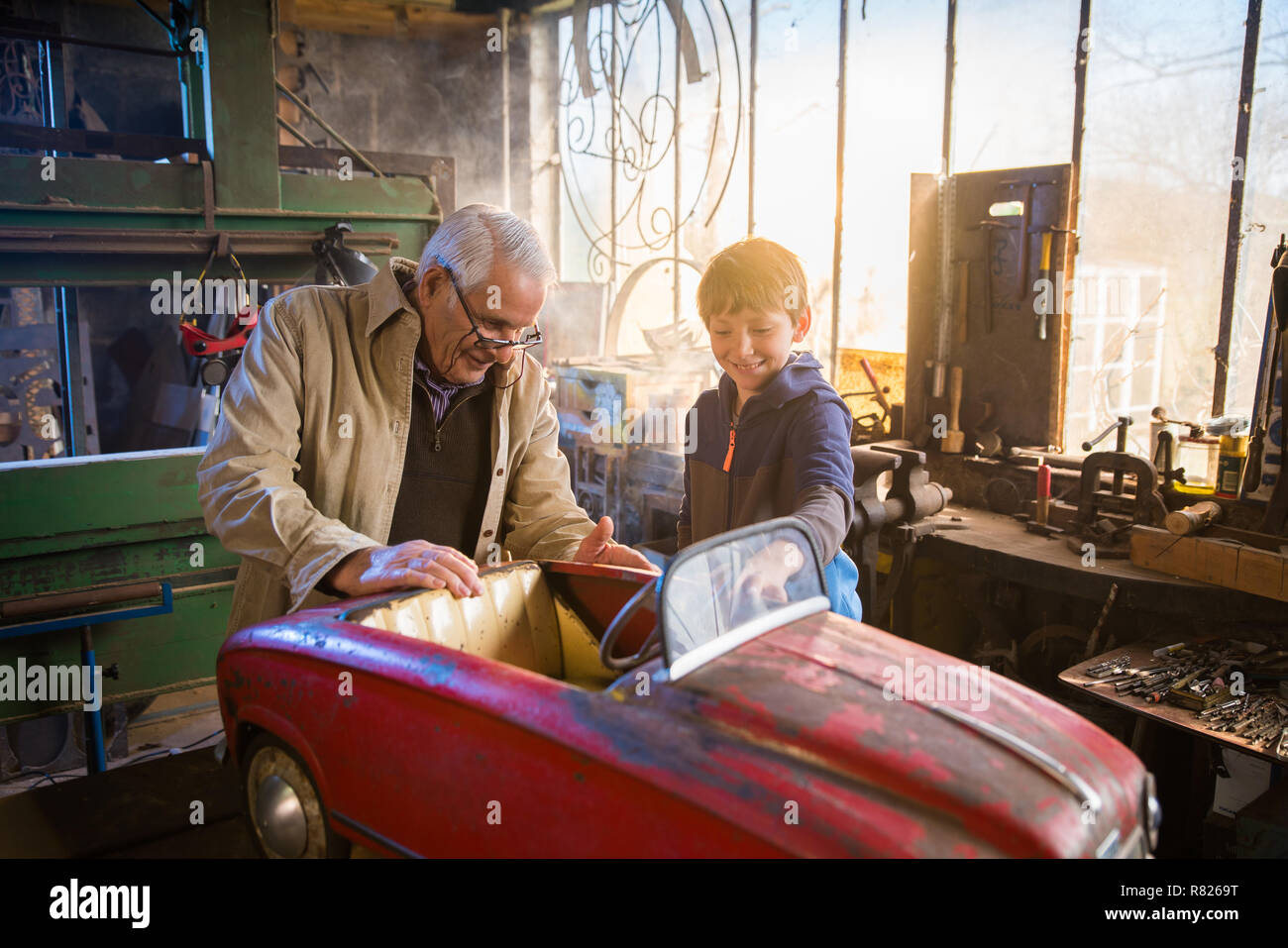 A grandfather and his grandson in the DIY workshop Stock Photo