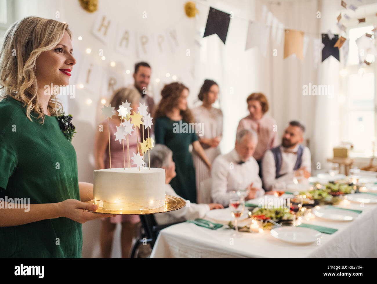 Old woman holding birthday cake hi-res stock photography and images - Alamy