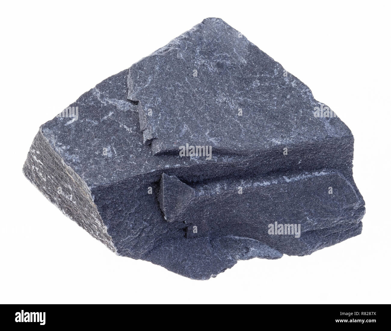 macro photography of natural mineral from geological collection - raw black argillite stone (mudstone) on white background Stock Photo