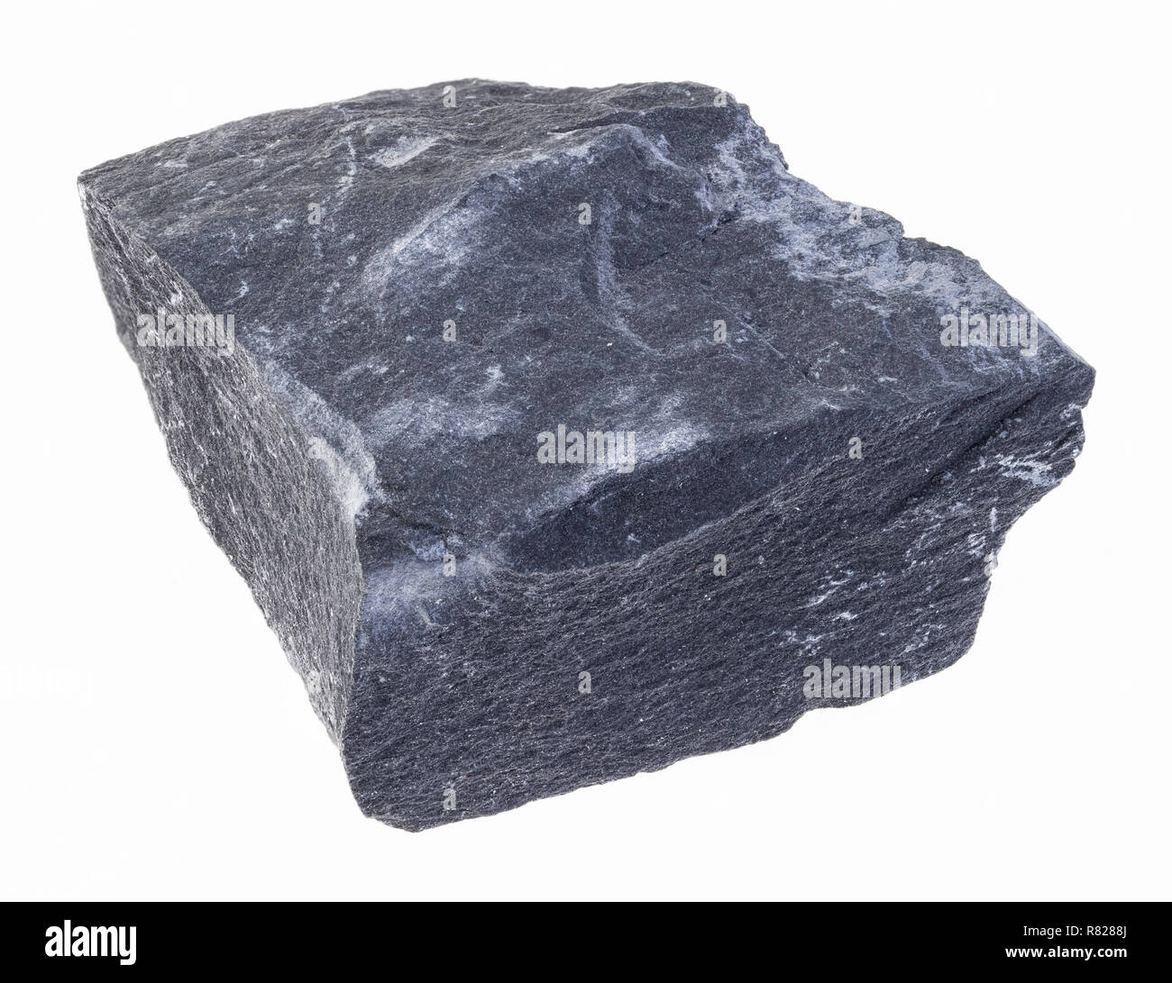 macro photography of natural mineral from geological collection - rough black argillite stone (mudstone) on white background Stock Photo