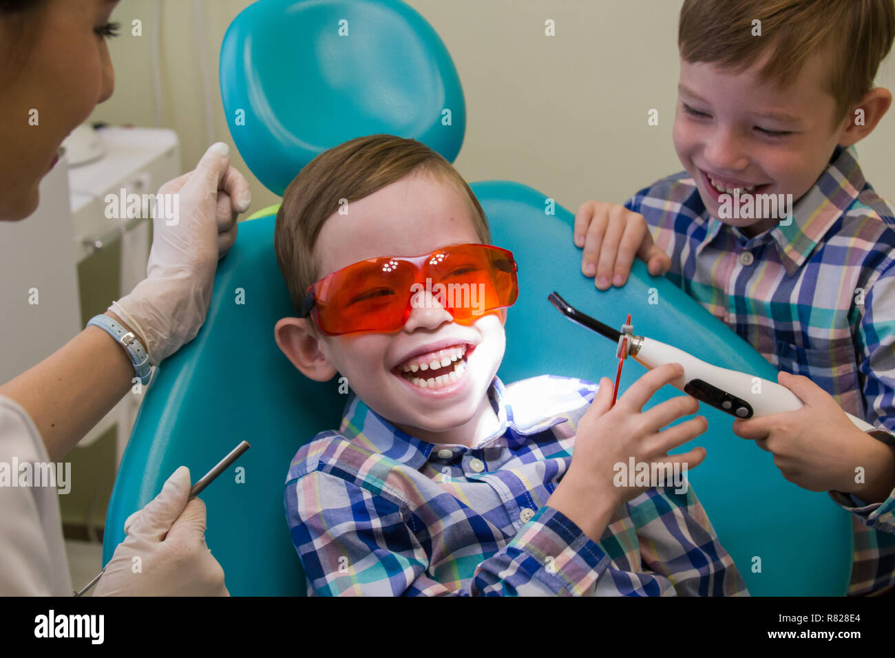 Reception at the dentistry. A smiling little boy lays on the couch and