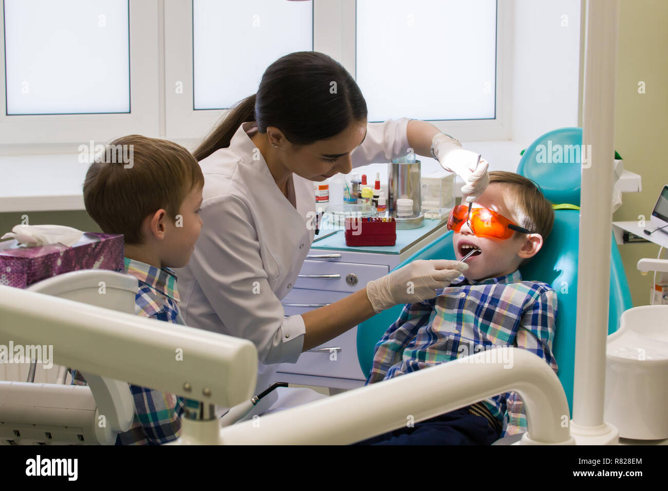 Reception at the dentistry. Two boys in the A little boy lays