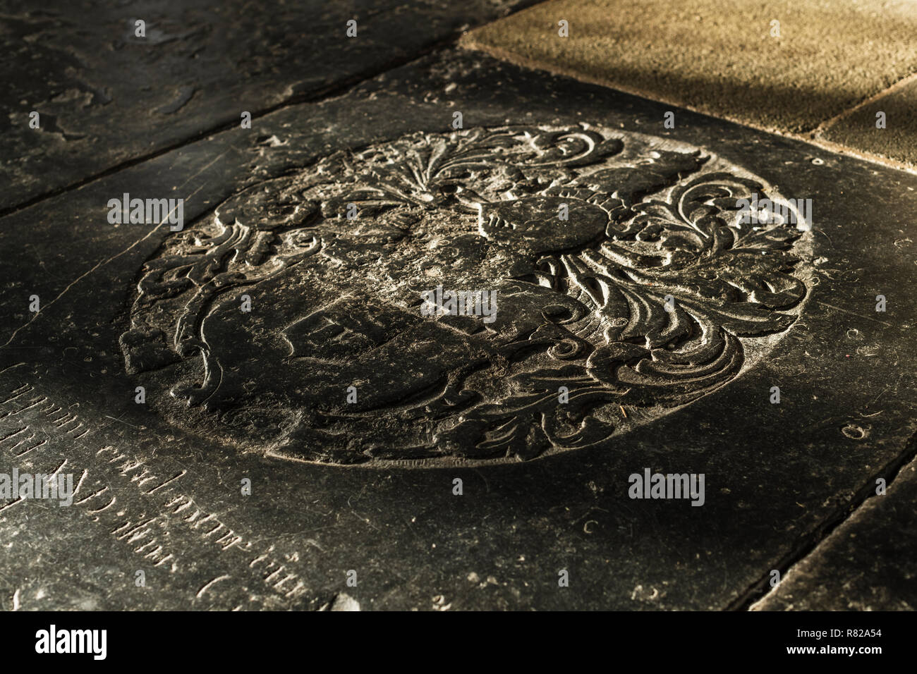 A weathered black marble Ledgerstone laid into the cathedral floor near the Lady Chapel at Wells in Somerset. Stock Photo