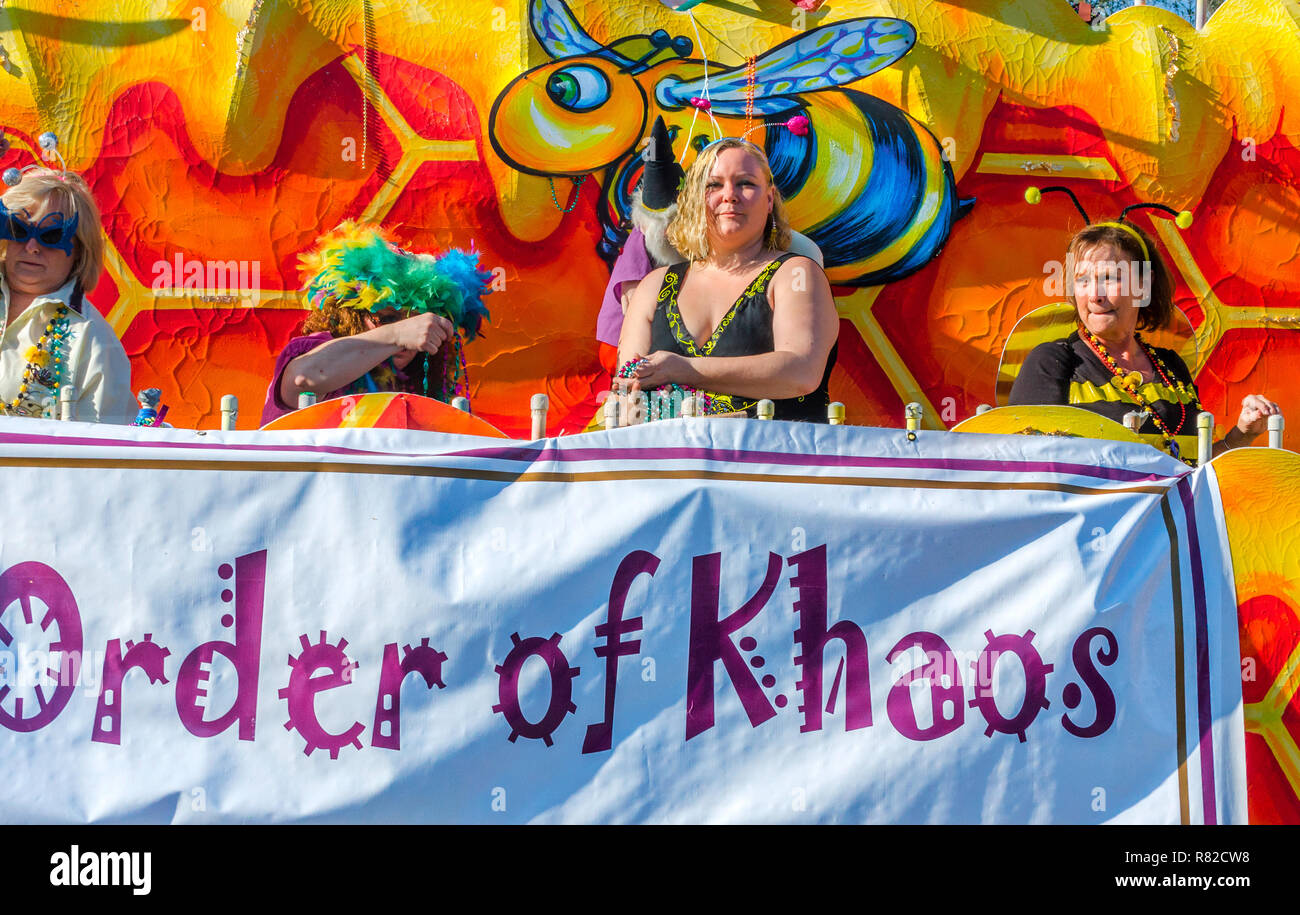 Members of the Order of Chaos throw beads to the crowd as travel down