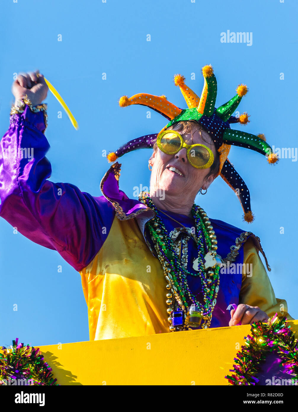 A reveler throws trinkets to the crowd as his float travels down Canal
