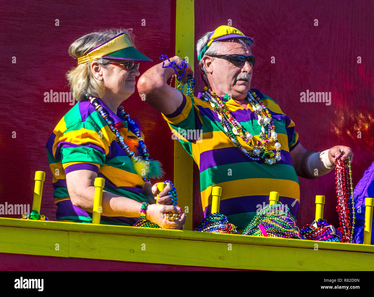 Revelers throw trinkets to the crowd as their float travels down Canal