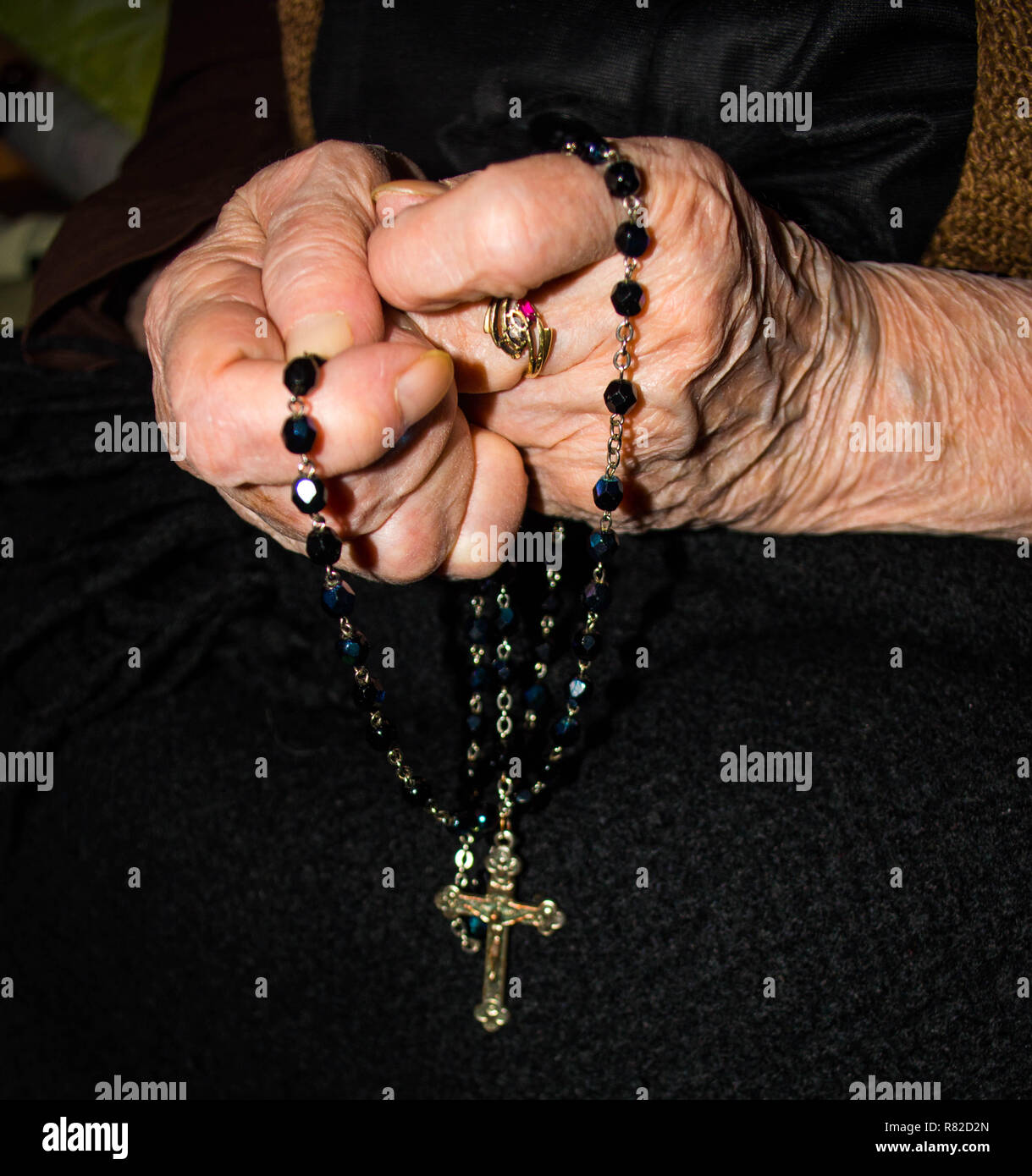 prayer hands with rosary