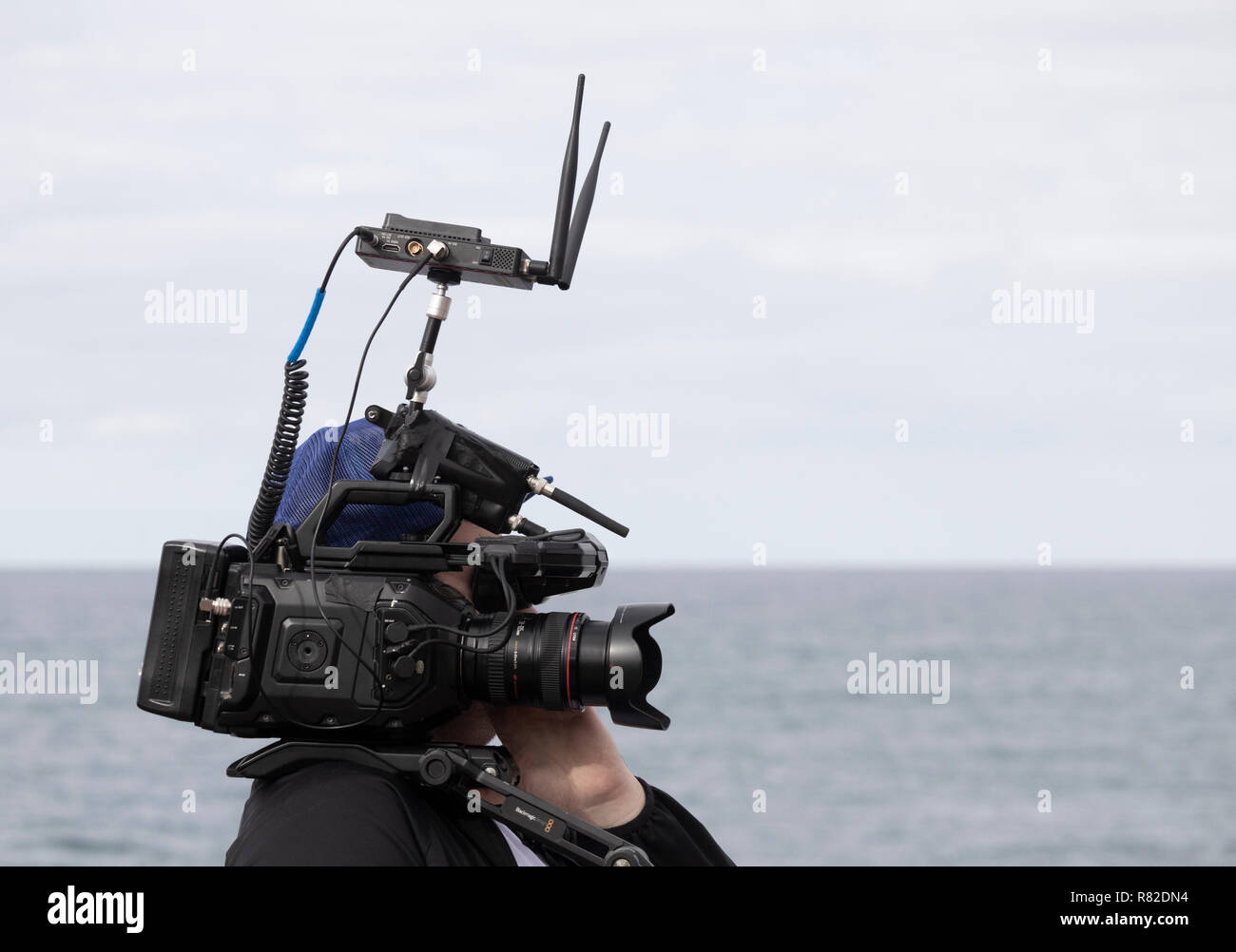Video camera with wifi router streaming live coverage of surfing event. Stock Photo