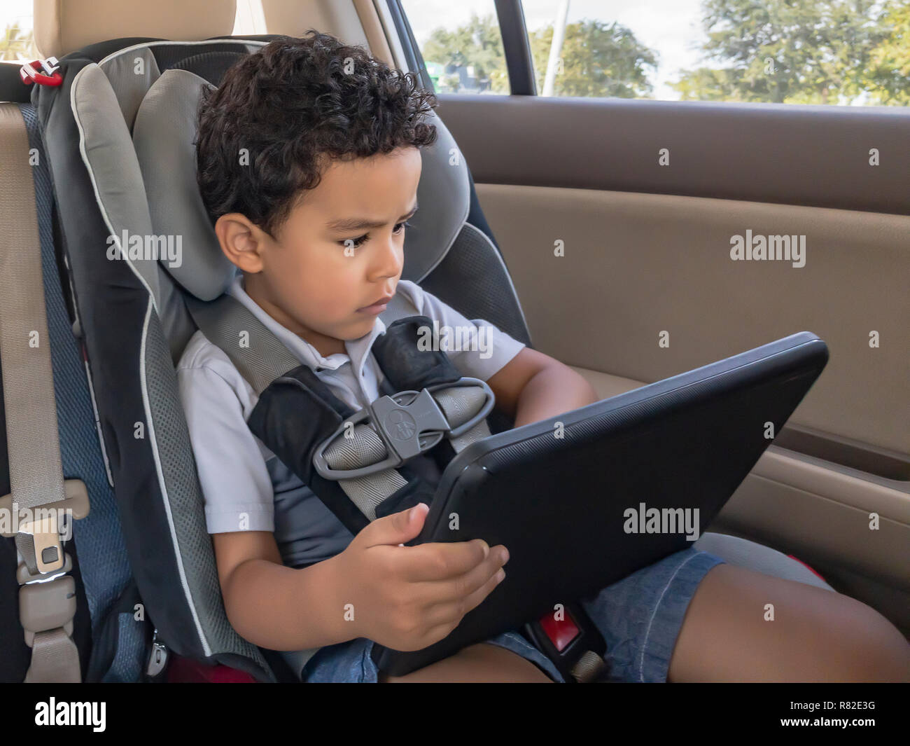 Child strapped in car seat hires stock photography and images Alamy