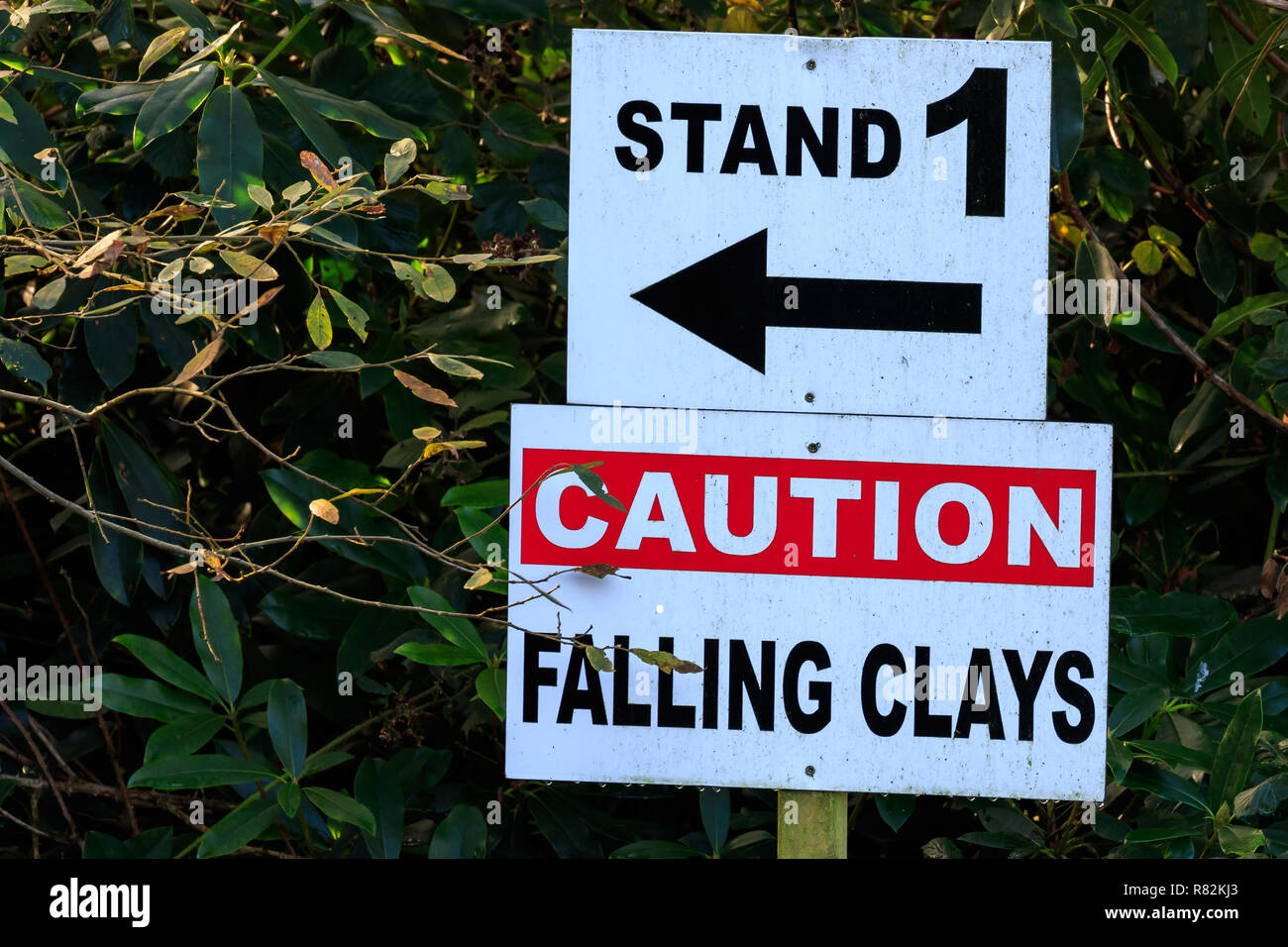 Caution falling clays sign at a shooting grounds Stock Photo