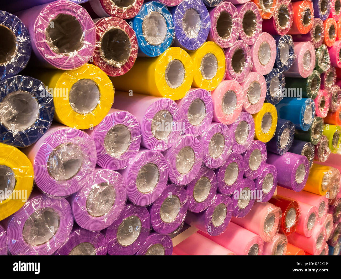 Rolls of decorative wrapping paper of different colors are on the store