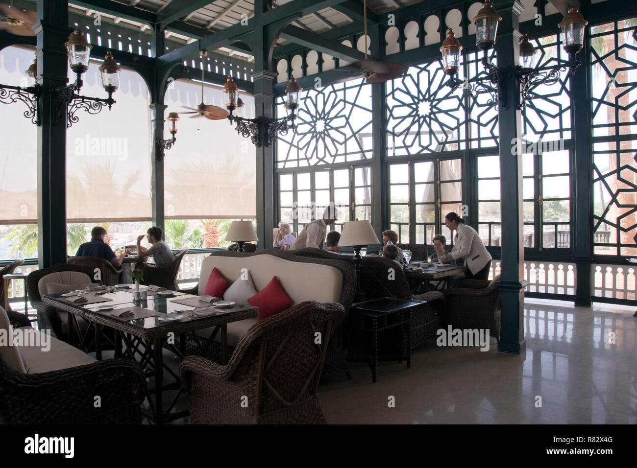 Guests dine on the terrace of the Old Cataract Hotel, an historic British colonial-era hotel that overlooks the Nile, Aswan, Egypt. Stock Photo