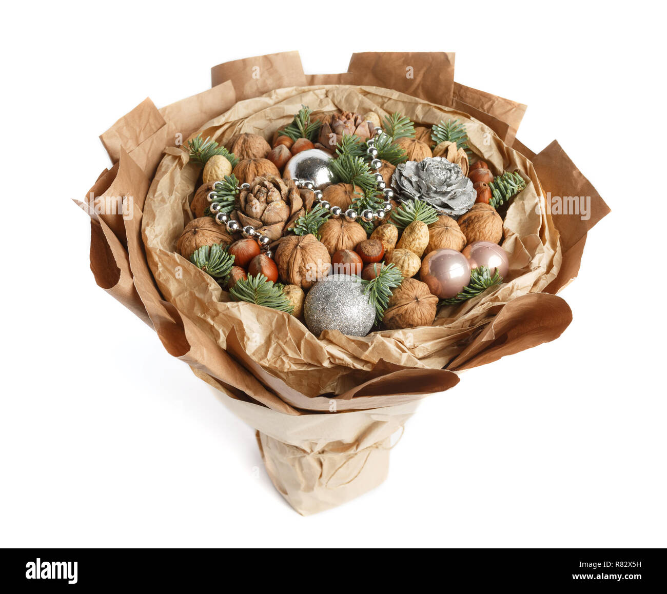 Beautiful Christmas decorative bouquet of various nuts, decorated with twigs of Christmas tree and balls. Top view Stock Photo