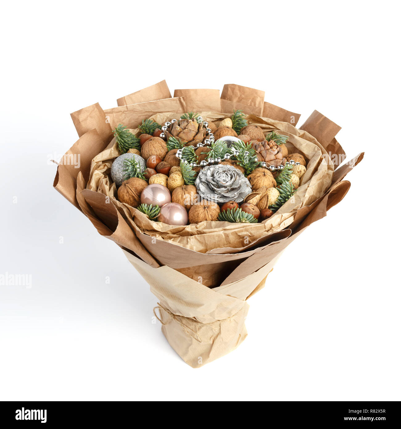 Beautiful Christmas decorative bouquet of various nuts, decorated with twigs of Christmas tree and balls Stock Photo