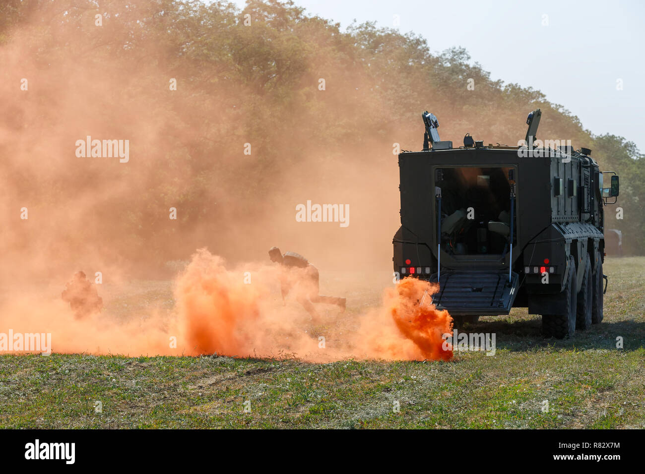 Russian special forces soldiers will regroup on the battlefield using a orange smoke screen Stock Photo