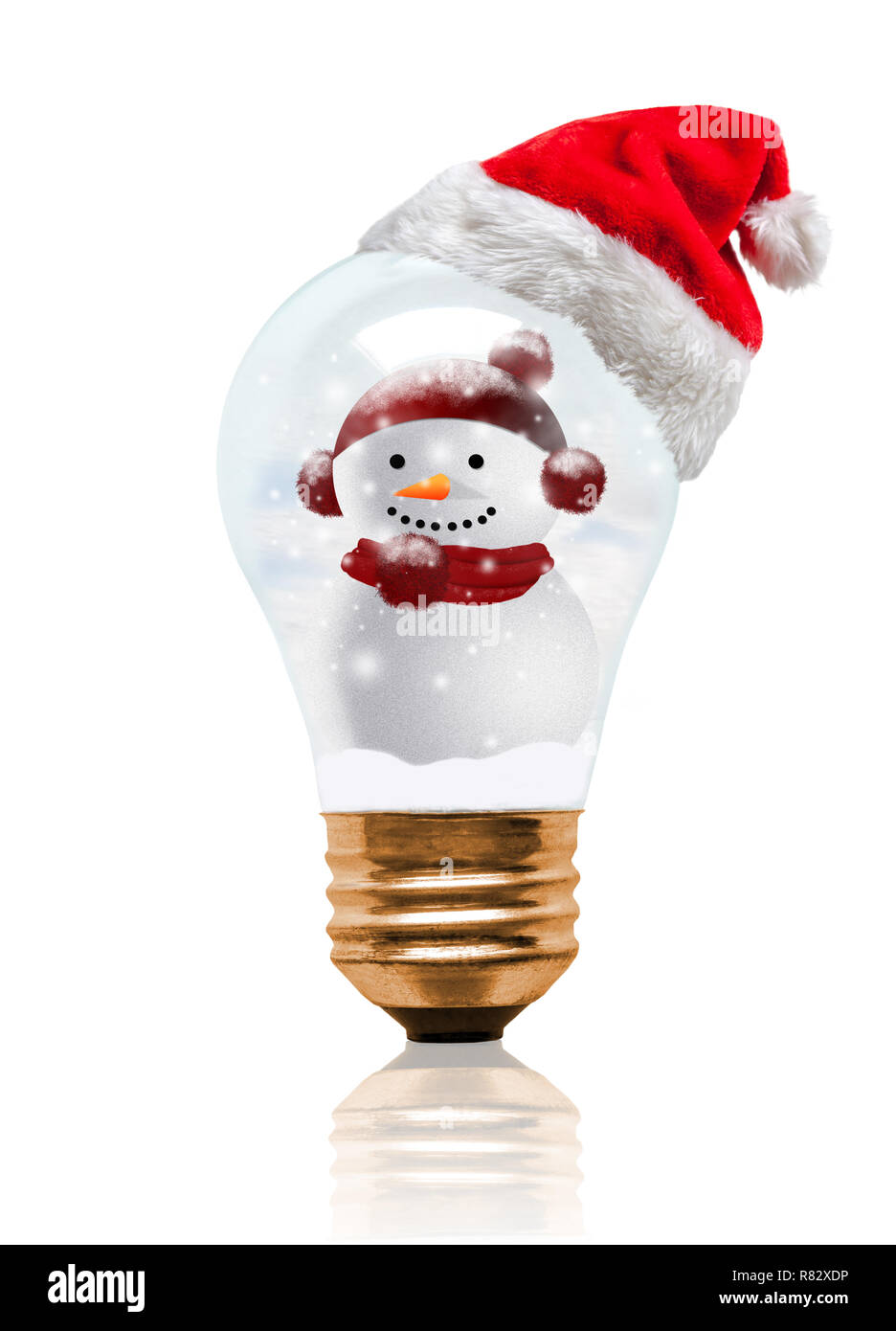 Snow globe light bulb wearing Santa hat with decorated snowman and copy space. Glowing Xmas season and bright New Year. Stock Photo