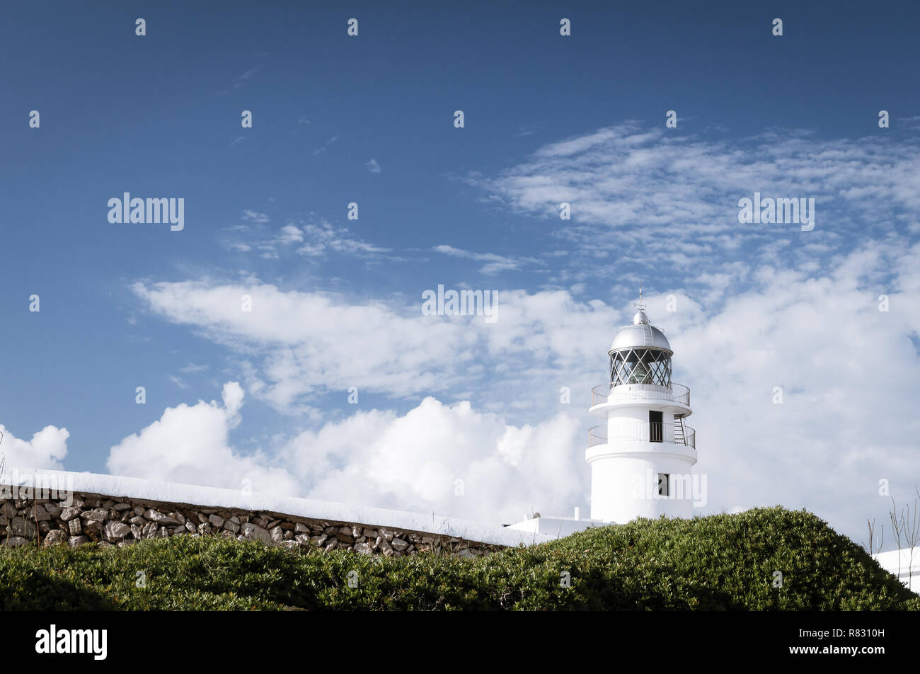 Traditional white light house in a sunny day in Cap Cavallería, Menorca, Balearic Islands, Spain. Stock Photo