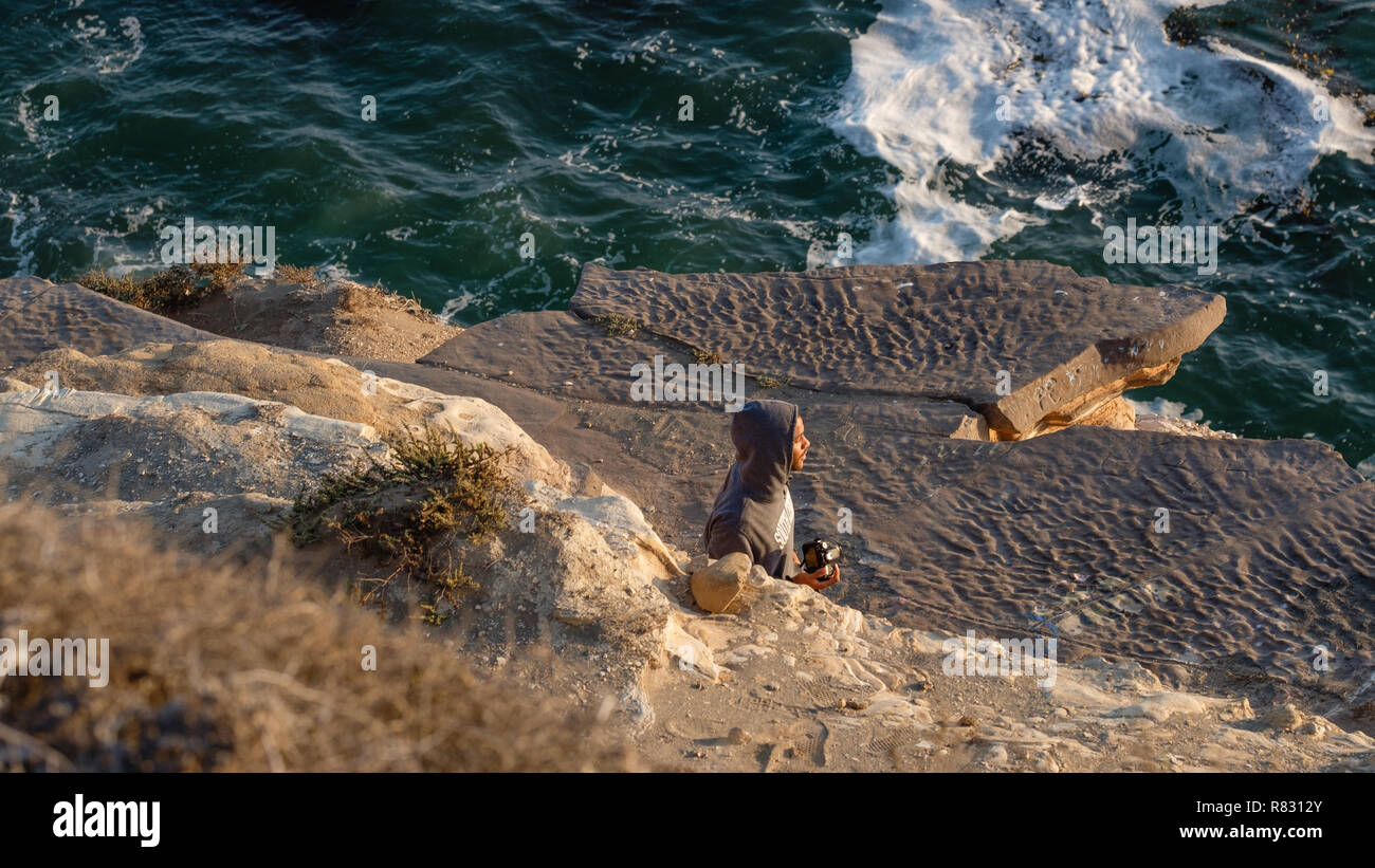 The Vida Photo:  Avid photographer roaming the cliff at Point Fermin, in San Pedro, CA.  It has been the scene of both suicides and accidental deaths. Stock Photo