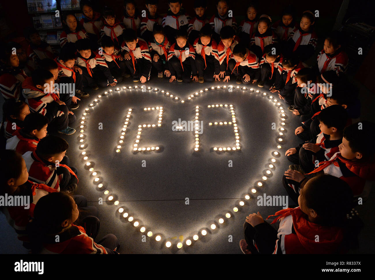Handan, China. 12th Dec, 2018. People light candles to mark the National Public Memorial day of Nanjing Massacre in Handan, north China's Hebei Province. Credit: SIPA Asia/ZUMA Wire/Alamy Live News Stock Photo