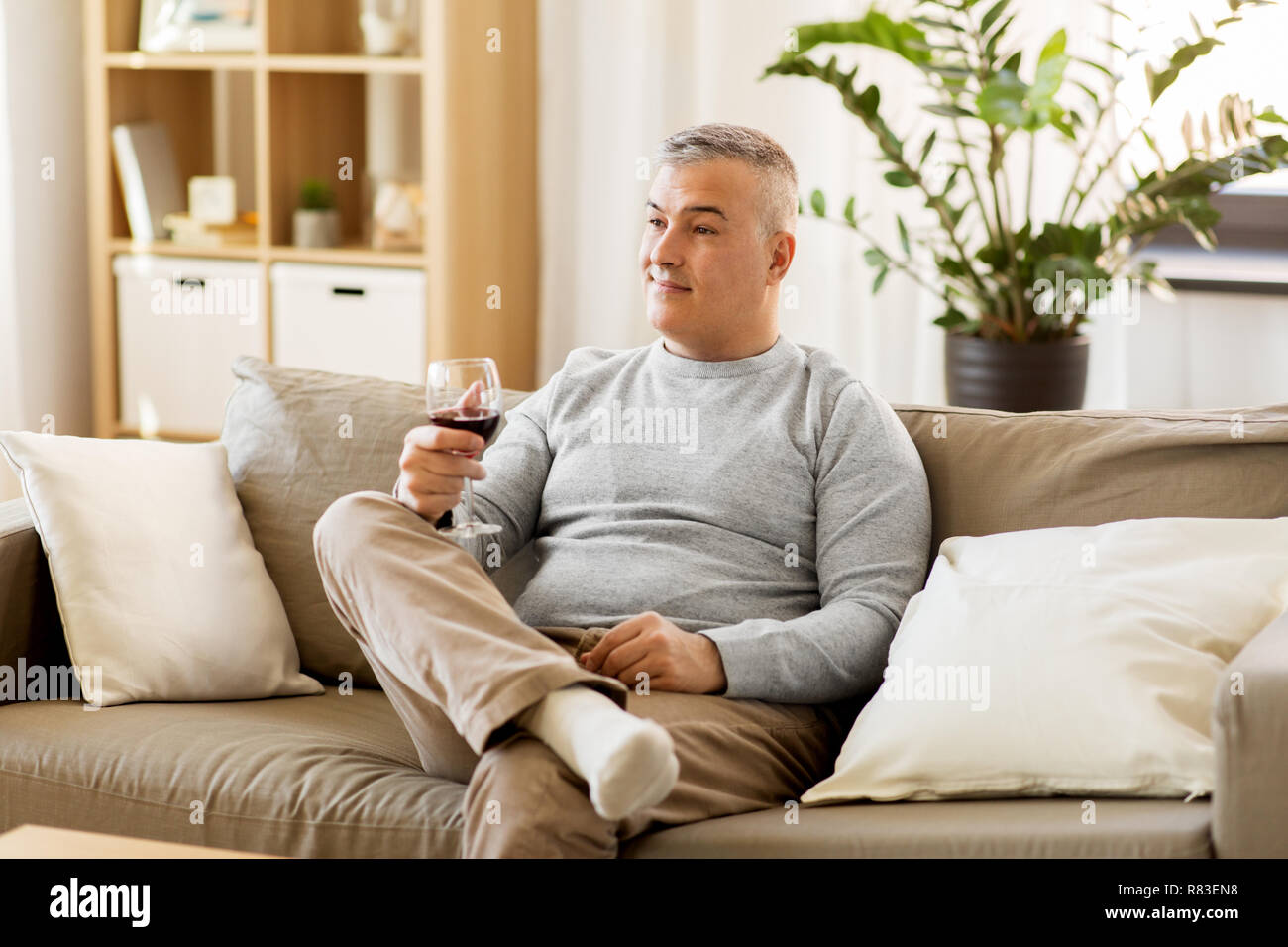 man drinking red wine from glass at home Stock Photo