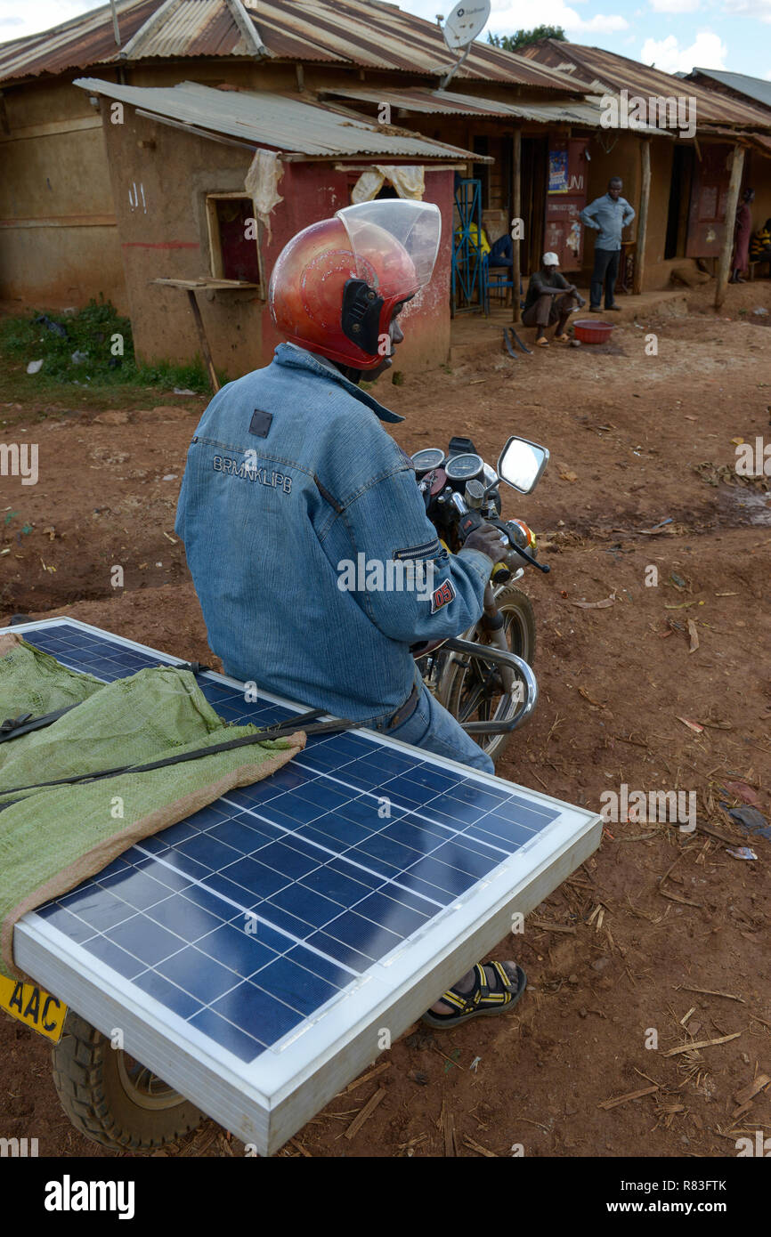 TANZANIA, Tarime, transport of PV solar panel by motorbike / Transport