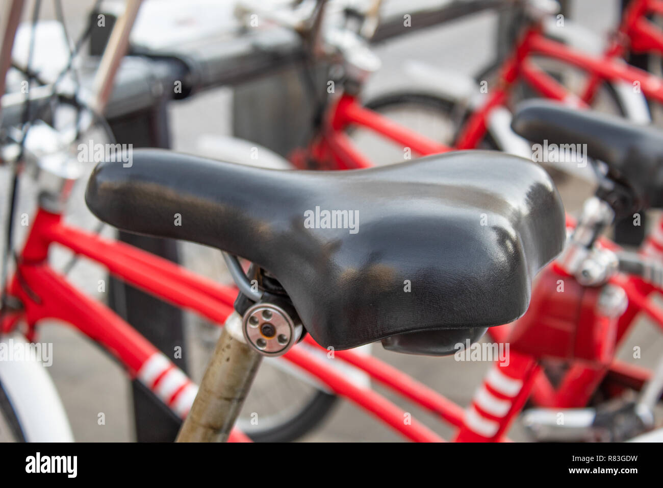 Bicycle saddle close-up of red bikes in the city Stock Photo