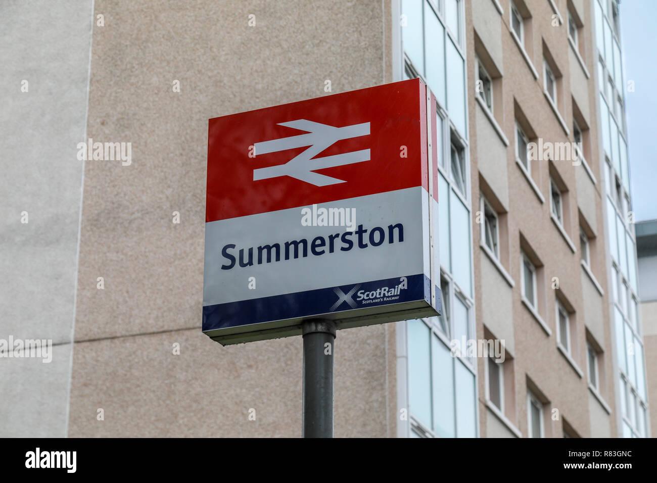 The station sign at the entrance to Summerston train station in North Glasgow Stock Photo