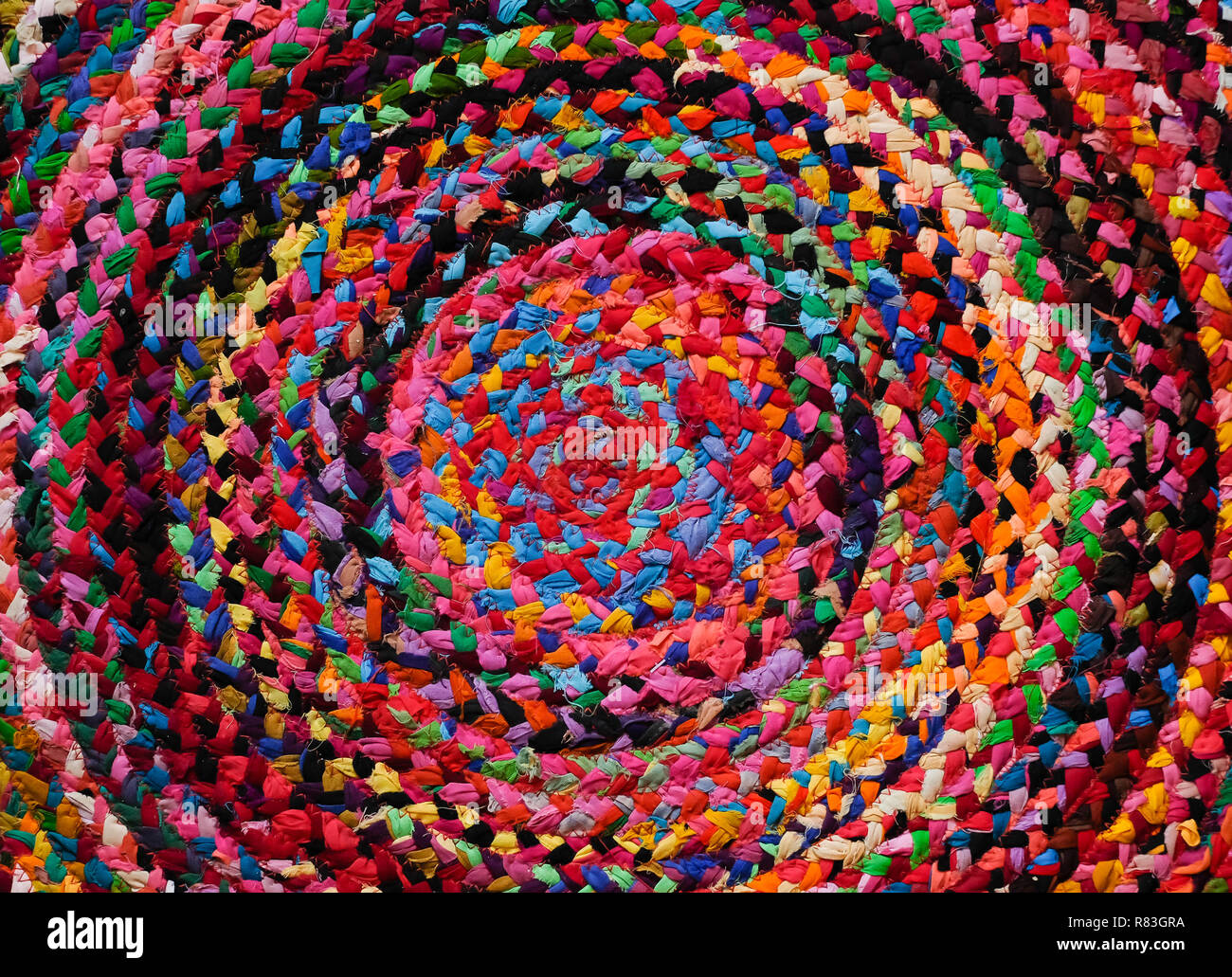 Colorful round african peruvian style rug or woven carpet surface close