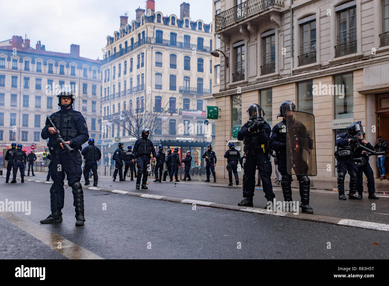 French riot police with tear gas for Yellow Vests (Gilets Jaunes) protesters against fuel tax, government, and French President Macron. Lyon, France. Stock Photo