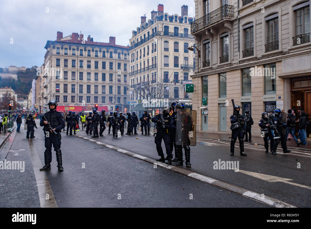 French riot police with tear gas for Yellow Vests (Gilets Jaunes) protesters against fuel tax, government, and French President Macron. Lyon, France. Stock Photo