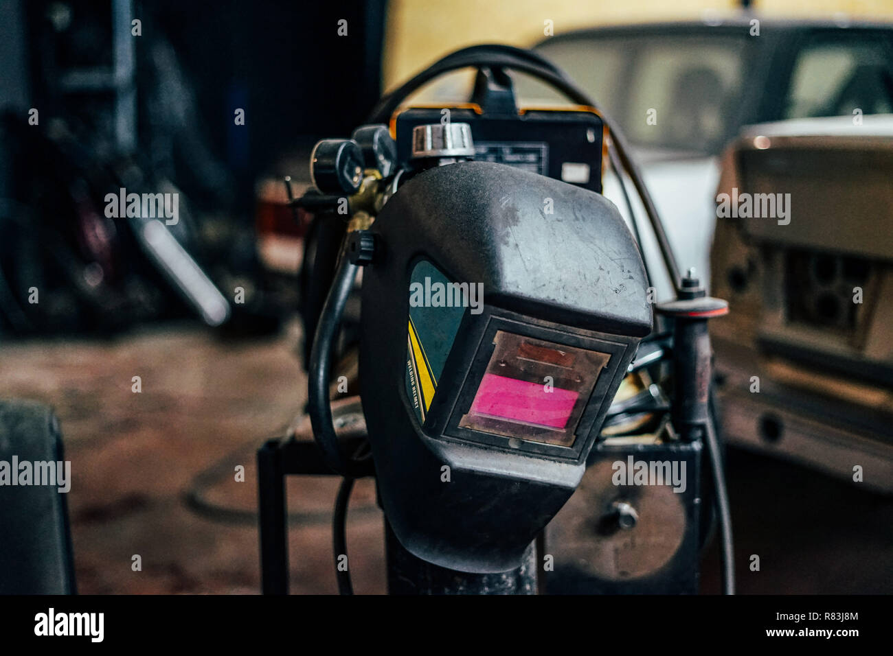 Welding mask on garage workshop background Stock Photo